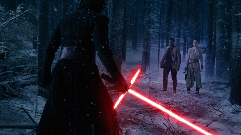 Kylo Ren wielding his lightsaber against Finn and Rey