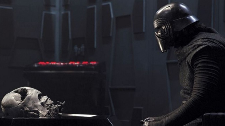 Kylo Ren looks at Darth Vader's mask