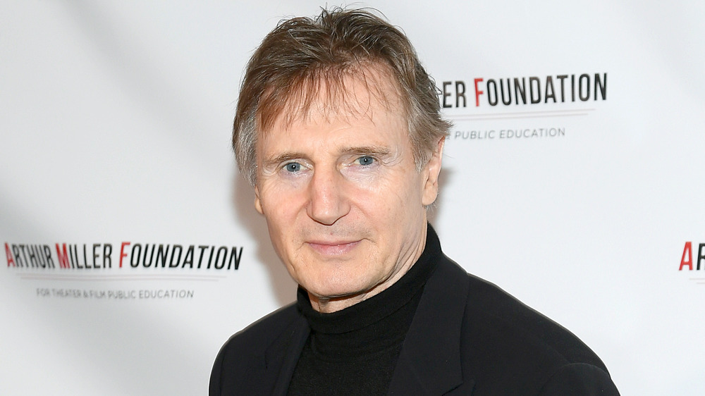 Liam Neeson black shirt and coat