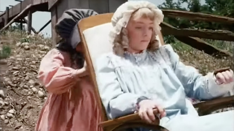 Laura Ingalls pushes Nellie Oleson down a hill