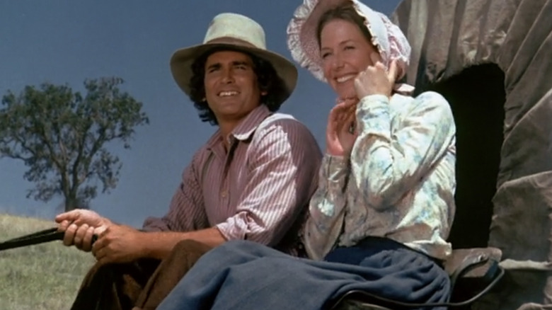 Charles Ingalls and Caroline Ingalls ride on wagon