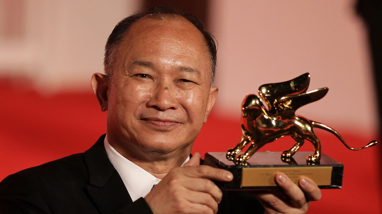 John Woo holding his Golden Lion Lifetime Acheivement Award in 2010