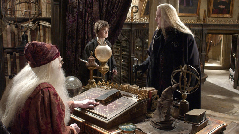 Lucius stands before Dumbledore