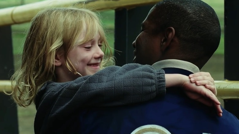 Dakota Fanning smiling at Denzel Washington