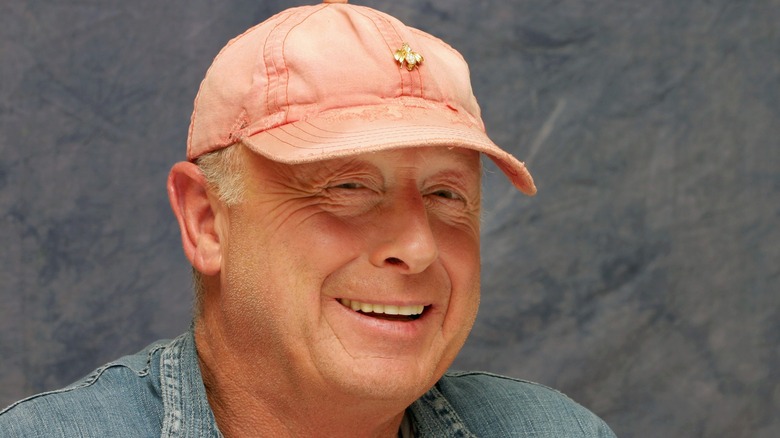 Smiling Tony Scott wearing a hat