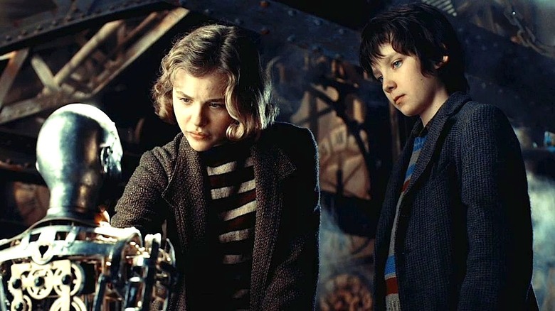 Chloe Grace Moretz and Asa Butterfield looking at automaton