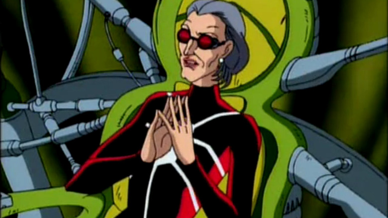 Madame Web holds presses fingers together in chair