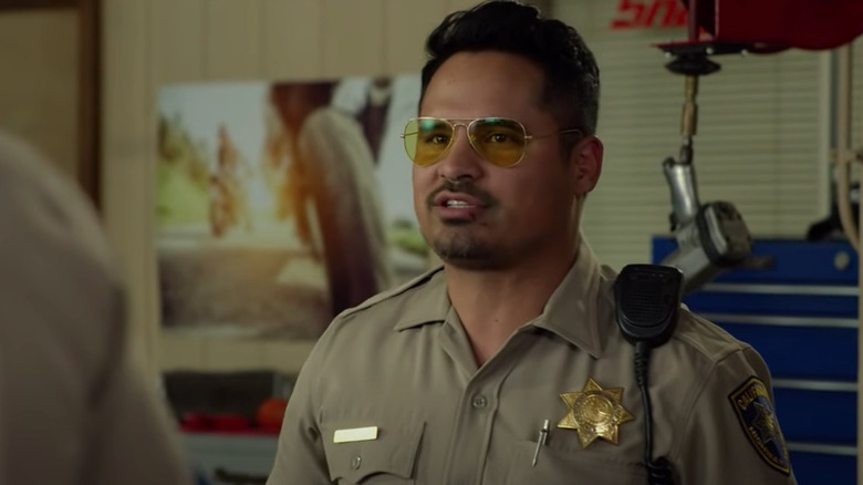 Michael Pena police uniform in motorcycle shop