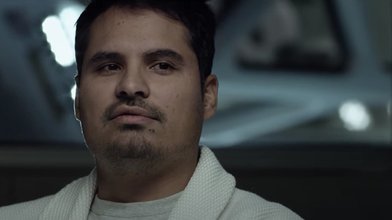 Michael Pena in robe in interrogation room