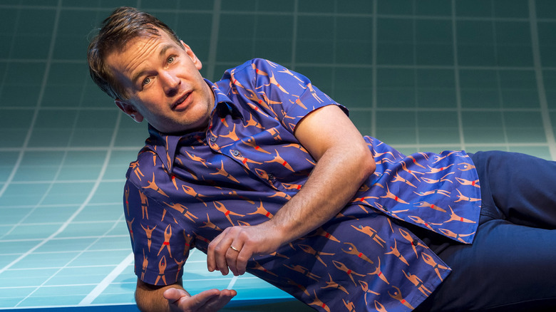 Mike Birbiglia lying on stage in "The Old Man and the Pool"