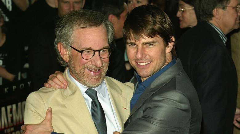 Steven Spielberg and Tom Cruise hug each other