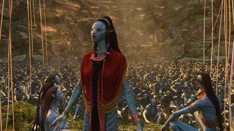 Mo'at standing and leading the Na'vi in prayer