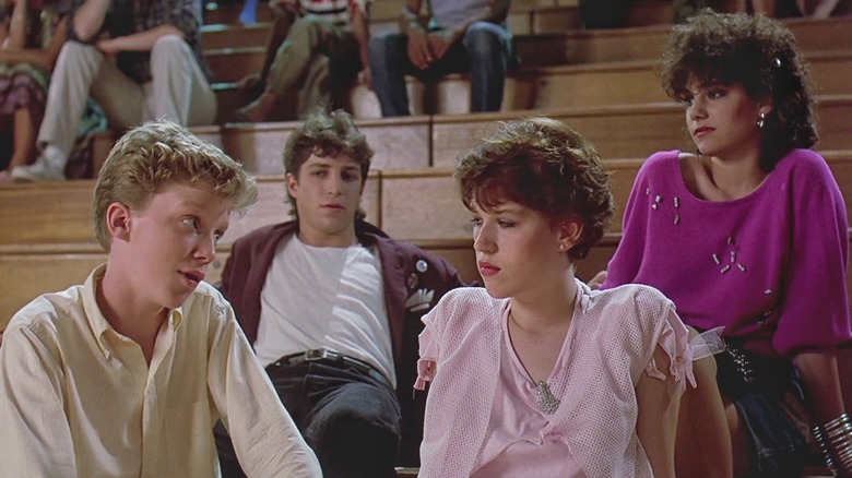 Group of kids talking on gym bleachers