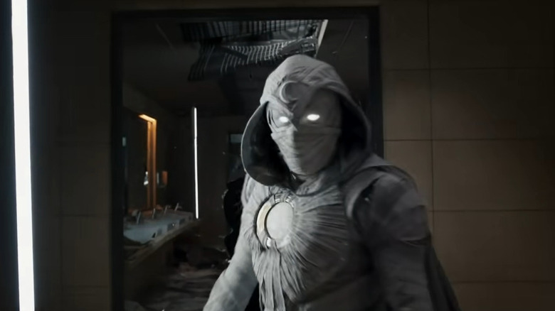 Moon Knight stands in front of a bathroom mirror