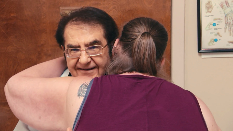 Dr. Now hugging a patient