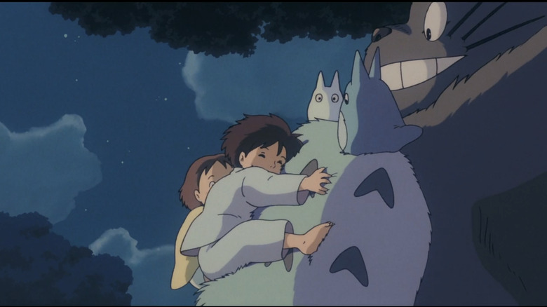 Mei and Satsuki hugging Totoro