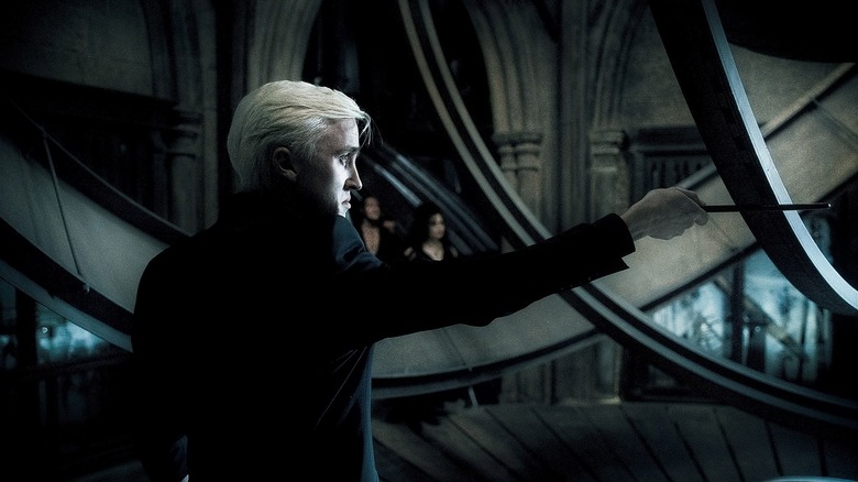 Draco Malfoy pointing wand at Dumbledore