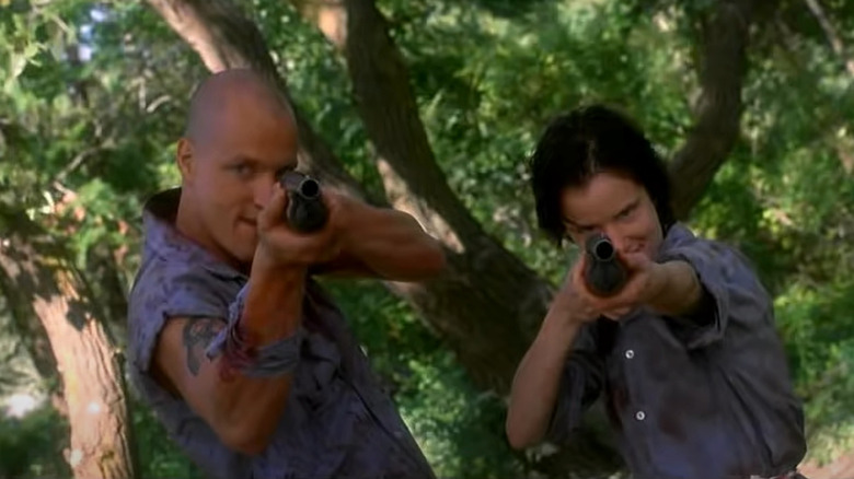 Mickey and Mallory aiming guns