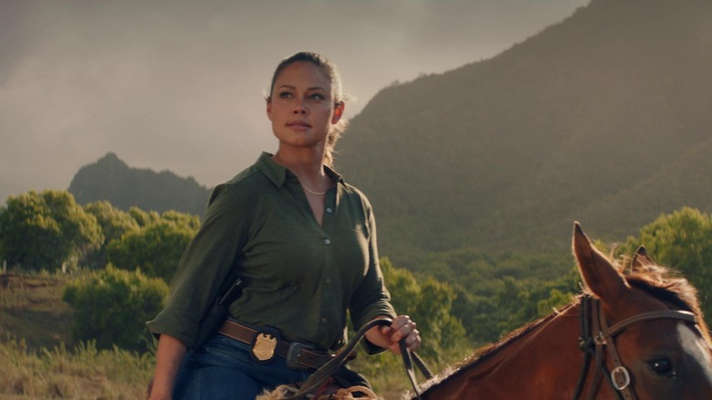 Tennant riding a horse in mountains 