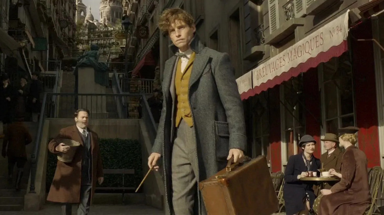 Newt carrying his briefcase