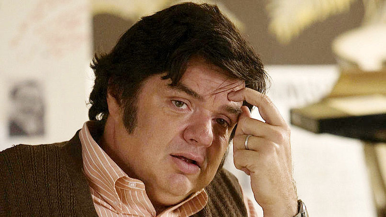 Oliver Platt with finger on forehead