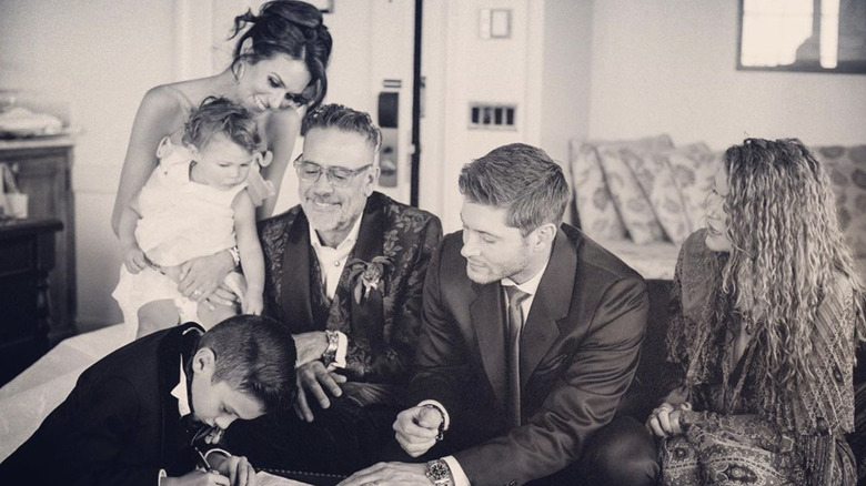 Group of people at a wedding and signing papers