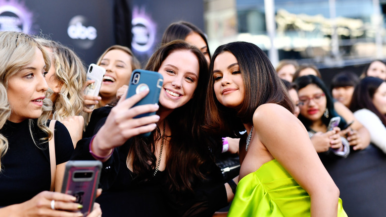 Selena Gomez posing with a fan