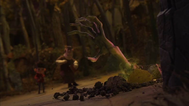 An undead hand popping out of the ground