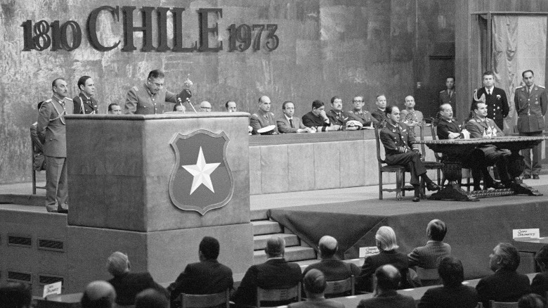 Augusto Pinochet delivers a speech to an audience