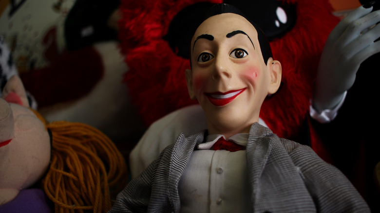 a Pee-Wee Herman doll in a pile of toys