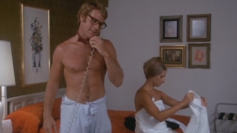 Ryan O'Neal without shirt holding phone What's Up, Doc?