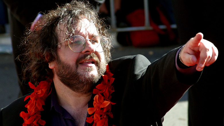 Peter Jackson wearing a garland and pointing