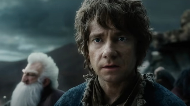 Martin Freeman as Bilbo Baggins beside the dwarves