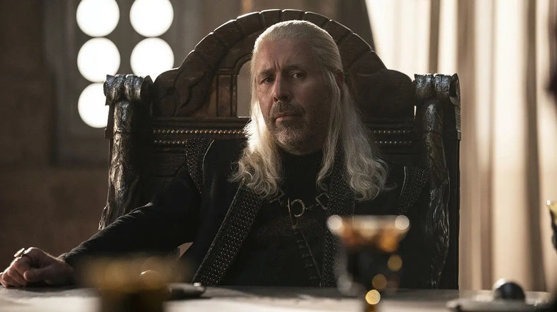 King Viserys I sits at table