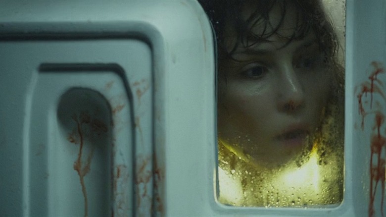 Noomi Rapace at window