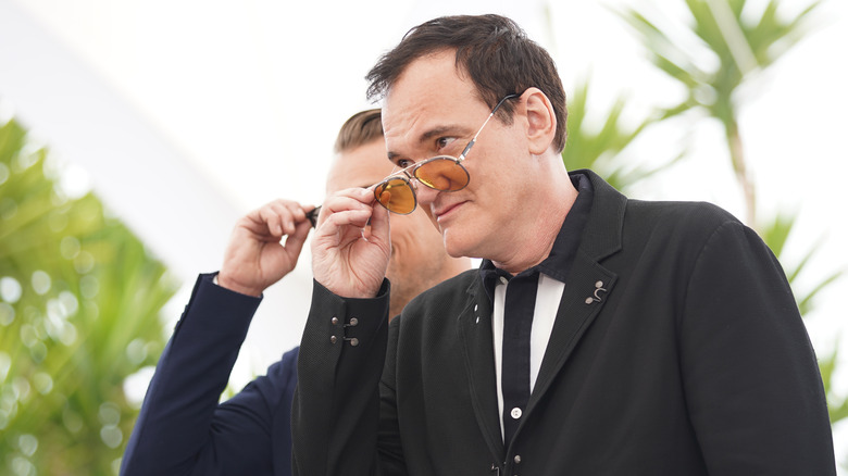 Quentin Tarantino taking off his glasses