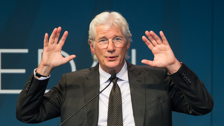 Richard Gere holding his hands up 