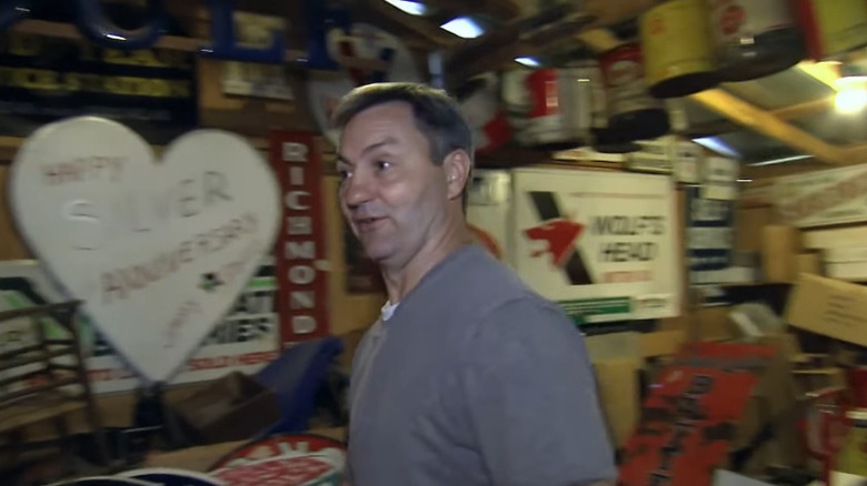 Robbie standing in front of vintage signs