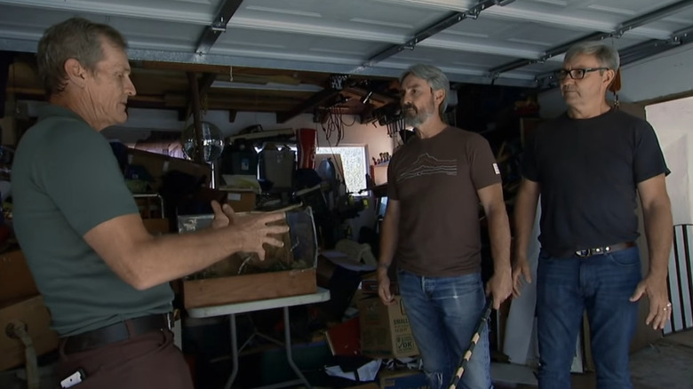 Robbie and Mike talking to man in garage