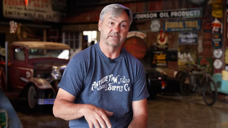 Robbie sitting in garage of collectibles