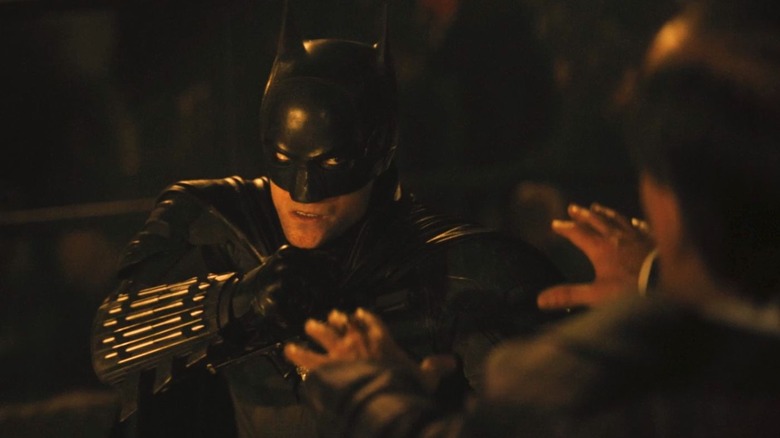 Batman about to punch a guy