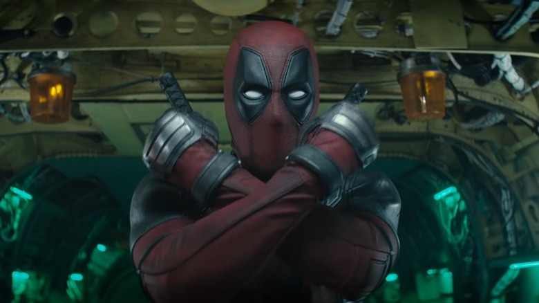 Deadpool making an X sign