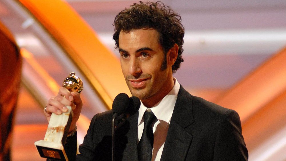 Sacha Baron Cohen holding a Golden Globe awar