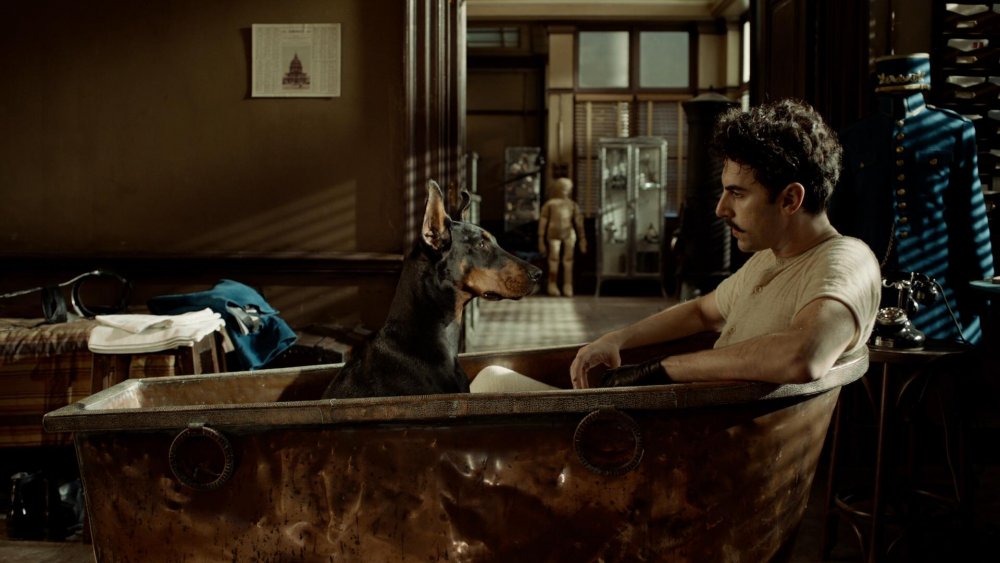 Sacha Baron Cohen in Hugo taking a bath with a dog