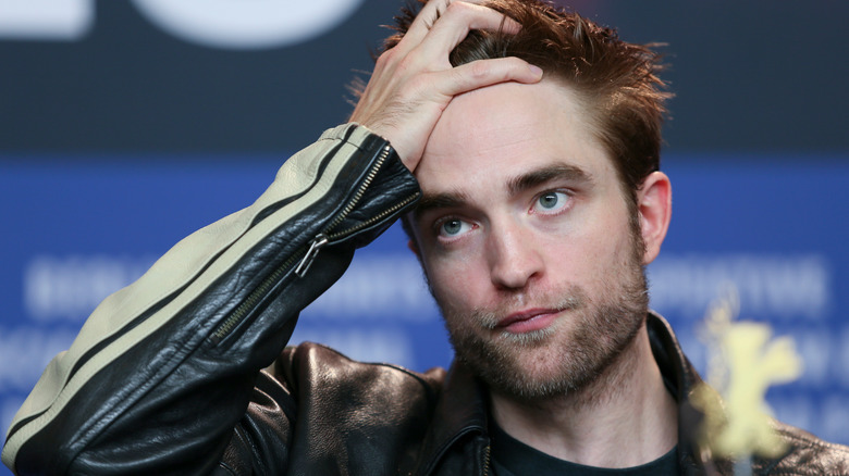 Robert Pattinson holding head