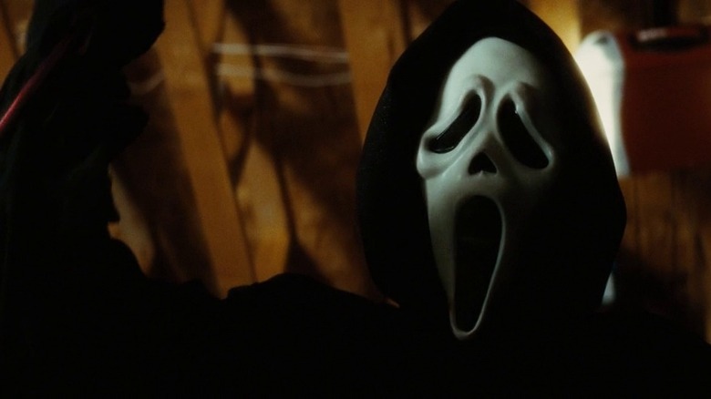 The Ghostface killer with their knife out Scream