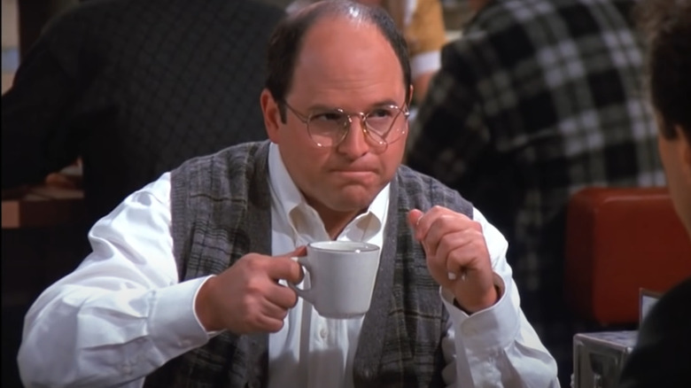 George Costanza holding a mug