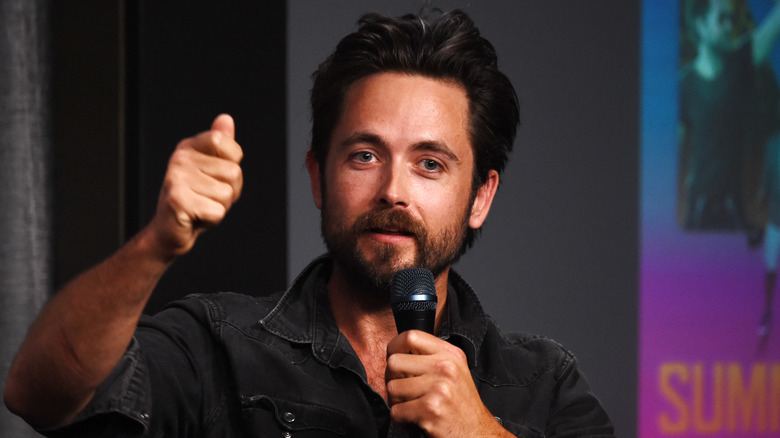 Justin Chatwin speaks into a microphone