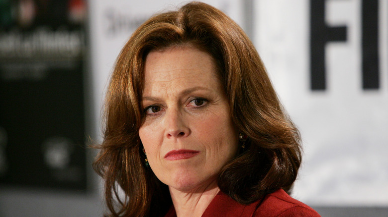 Sigourney Weaver in a red suit