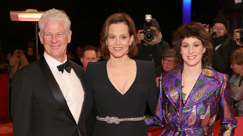 Sigourney Weaver posing with her husband and daughter